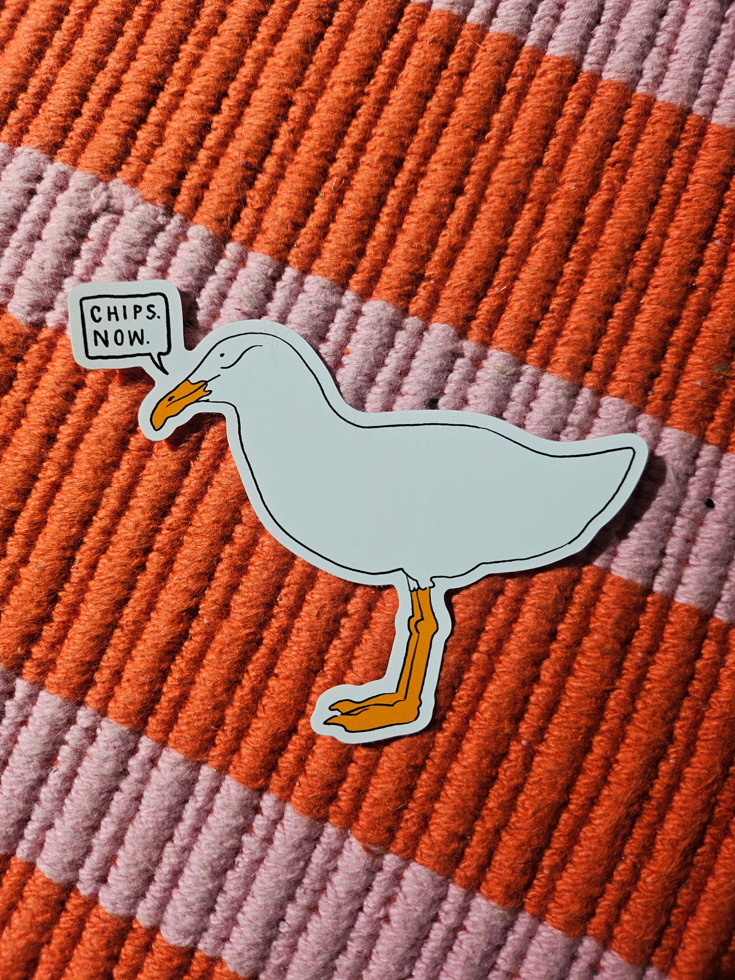 Sticker of a seagull saying "Chips. Now."